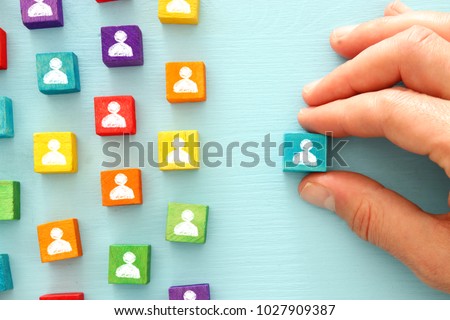 image of colorful blocks with people icons over wooden table ,human resources and management concept