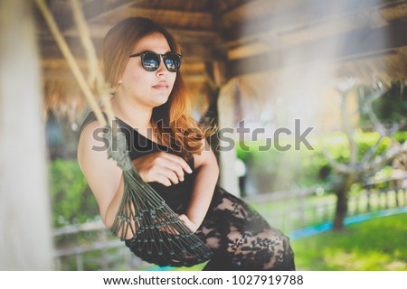 Woman relaxing in the hammock on tropical beach