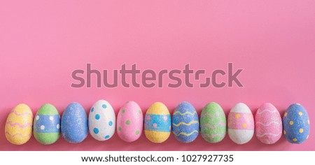 Colorful easter egg on pink pastel color background with space.