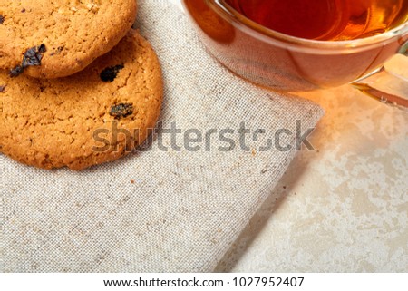 Top view close up picture of glass teacup with biscuits isolated on white background, frontfocus, shallow depth of field
