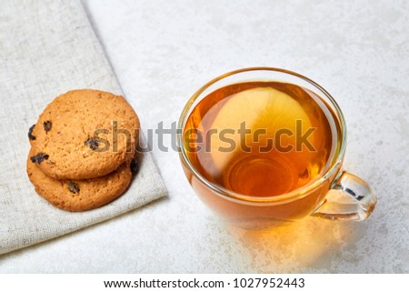Top view close up picture of glass teacup with biscuits isolated on white background, frontfocus, shallow depth of field