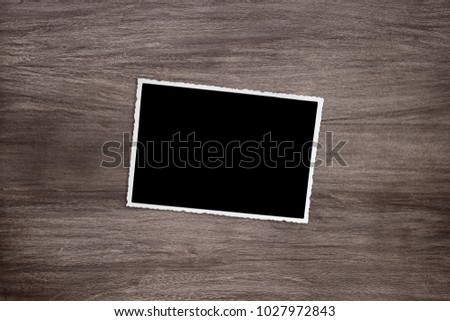 blacked out old vintage photo template on rustic wooden background