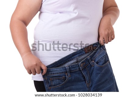 Fat asian woman trying to wear small size jeans isolated on white background. Fat and Healthcare concept