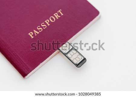 Red Passport with sim cards on a white background, close-up