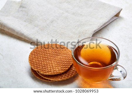 Top view close up picture of glass teacup with waffles isolated on white background, shallow depth of field