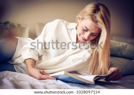 Time for me. Young woman riding book.  Royalty-Free Stock Photo #1028097154
