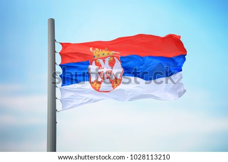 Flag of Serbia against the background of the sky
