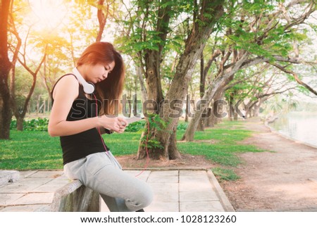 Asian woman in the park with tablet pc