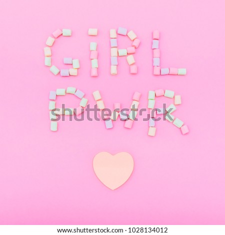 inscription GIRL PWR  laid out by marshmallow with heart on pink background. creative concept.  minimal