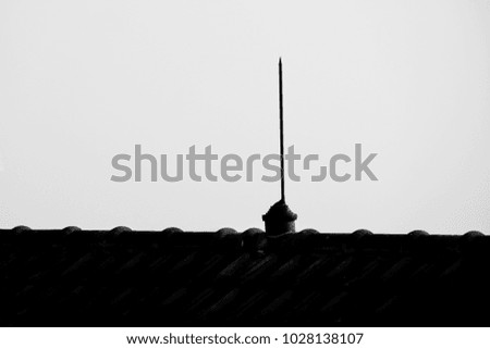 Lightning rod over Roof tiles. abstract, Black and White