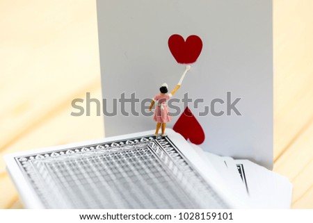 Miniature people : maid clean a heart of Playing cards.