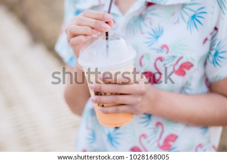 Thai girl drink cold tea