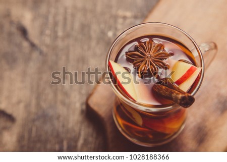 hot spicy beverage. Hot drink (apple tea, punch) with cinnamon stick and star anise. Seasonal mulled drink.