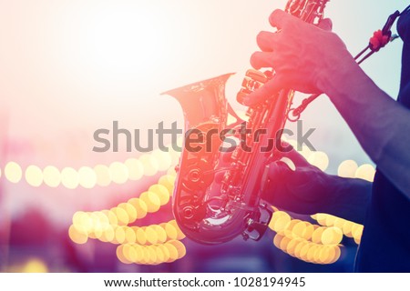 International Jazz day background. Saxophone, music instrument played by saxophonist player musician in festival Royalty-Free Stock Photo #1028194945