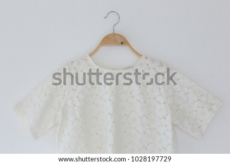 Natural color clothes is clothes hanger on white background.
