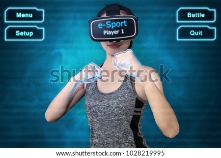 Young sport woman using VR goggle headset to play VR sport fighting game. e-Sport concept