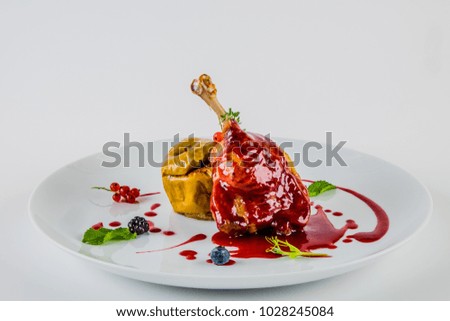 duck leg with baked apples and cranberry sauce