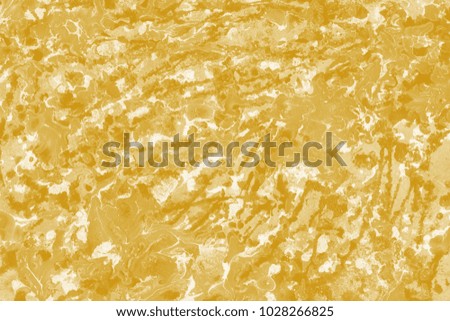 Gold wet abstract paint leaks and splashes texture on white watercolor paper background.