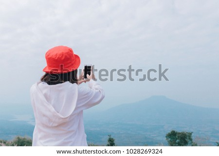 Asian women cheerful on the mountain, she taking pictures