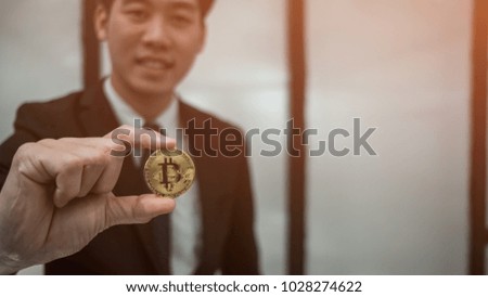 Business man holding bitcoin golden coin,  business trader concept