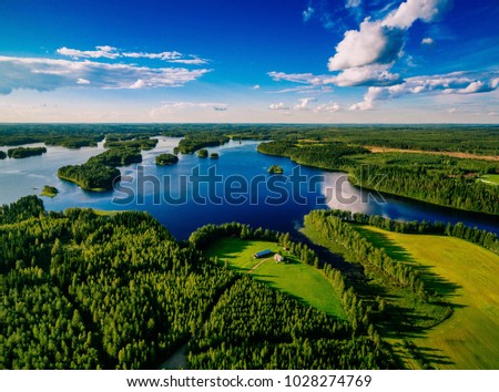 Aerial view of blue lakes and green forests on a sunny summer day in Finland. drone photography Royalty-Free Stock Photo #1028274769