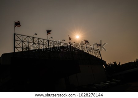 silhouette of  steel structure of large empty billboard outside the metal sheet wall of factory under sunny day