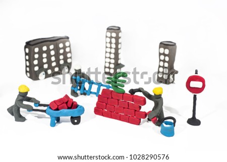 Abstract photo of buildings works. Figures made from Play Clay. Isolated on white background.