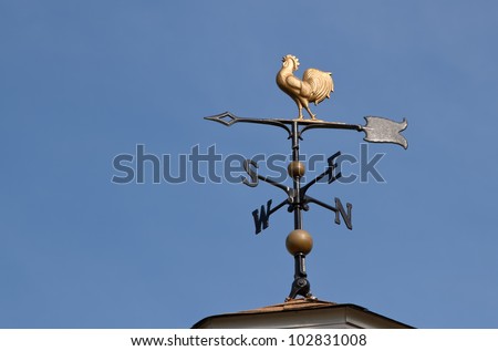 Weather vane  against a  blue sky Royalty-Free Stock Photo #102831008