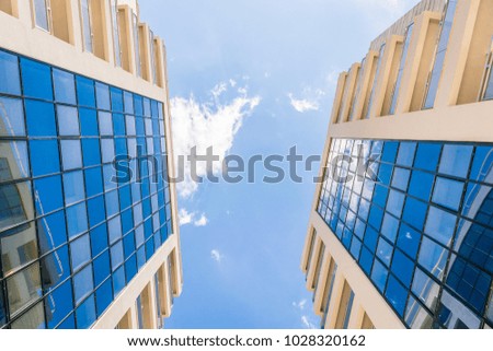 Two buildings with transparent windows and balconies. Modern architecture in the Budva city, Montenegro.  Royalty-Free Stock Photo #1028320162