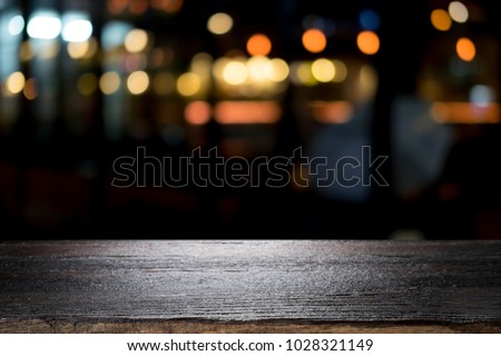 Empty wooden table platform and bokeh at night Royalty-Free Stock Photo #1028321149