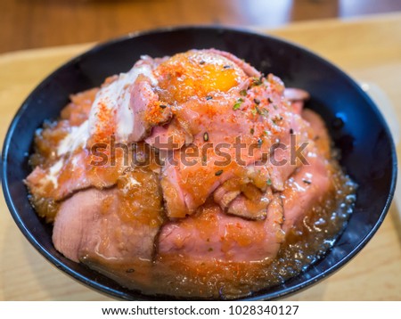 Japanese food - Roast Beef Don - roast beef pile over rice like volcano with egg yolk at center. - Close up