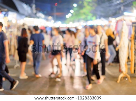 Group of people are looking for goods and service at the night market that It is free time or finish work 's them. Anything was take a picture to blur to describe abstract feelings.