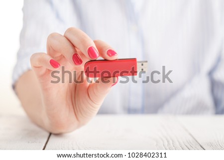 Female hold usb stick flash drive Royalty-Free Stock Photo #1028402311