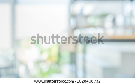 Abstract Blurred image of Outdoor Restaurant or Cafe with green bokeh for background usage.