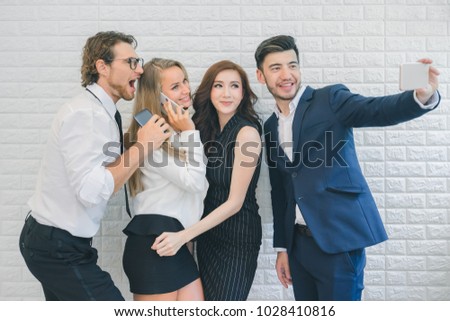 Professional business people happy and smiling, business team taking selfie by smartphone in the office, business people concept