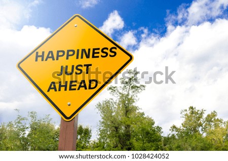 Happiness just ahead conceptual yellow road sign with blue sky with clouds and trees in background