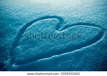 Heart shape drawing on snow