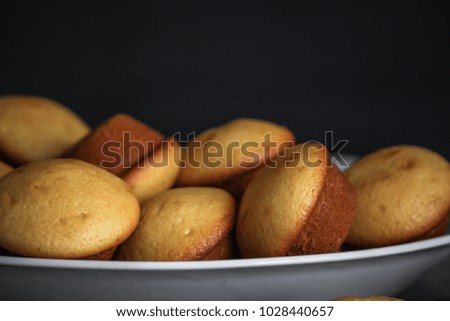 small muffins (cupcakes) - fresh pastries on a wooden surface