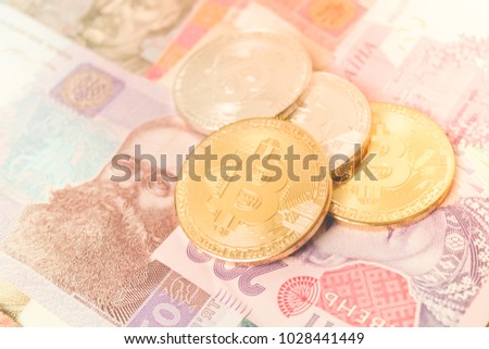 Ukrainian money banknots.Golden bitcoin.new virtual money cryptocurrency. Business concept.