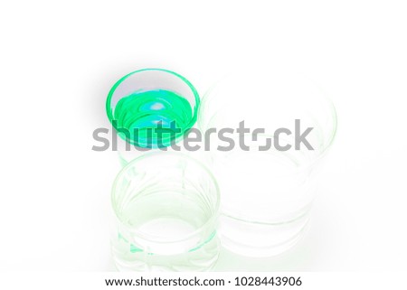 background with green and transparent glasses with water into the light