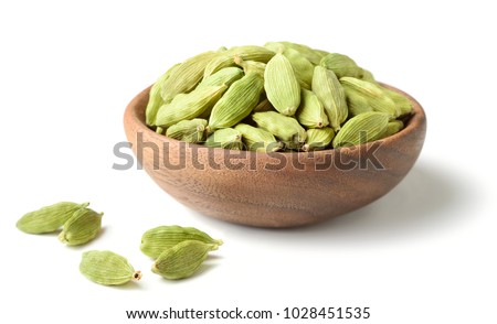 closeup of dried cardamom in the wooden plate Royalty-Free Stock Photo #1028451535