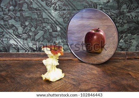 surrealistic picture of an apple reflecting in the mirror
