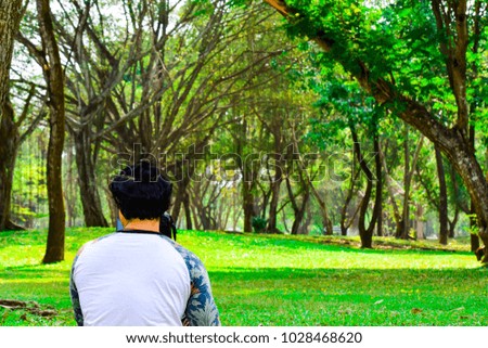 man takeing photo nature in the green forest or public park.landscape.walk way nature.tropical forest.