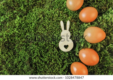 
Easter picture. Farmer's brown eggs on green moss. Happy easter.