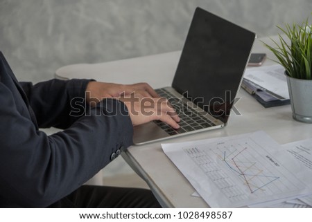 Close-up of hand business man using laptop at office.