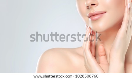 Beautiful Young Woman with Clean Fresh Skin. Face care  . Facial  treatment   . Cosmetology , beauty  and spa .  
 Royalty-Free Stock Photo #1028508760
