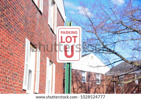 Red and white parking lot sign U