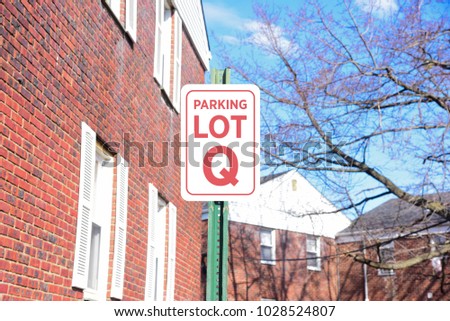Red and white parking lot sign Q