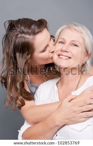 Loving Daughter kissing her mom on the cheek