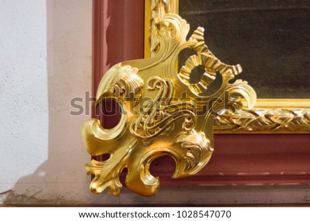 gilded bas-relief on the picture frame